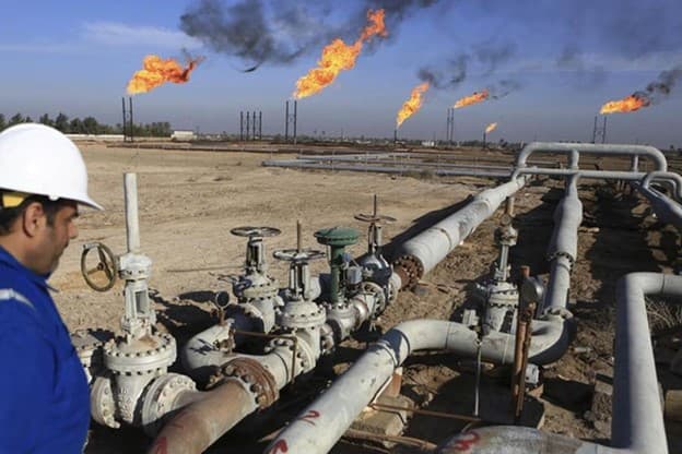 Oil and gas infrastructure with natural gas flares in the background, representing OXYNOil's expertise in energy sector operations