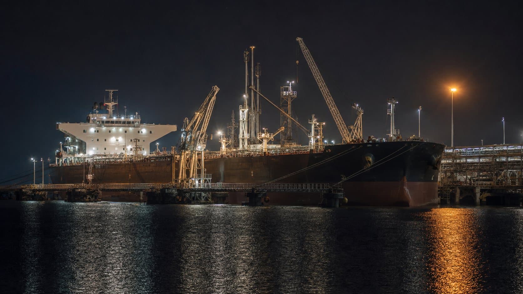 Tanker loading at a terminal berth at night